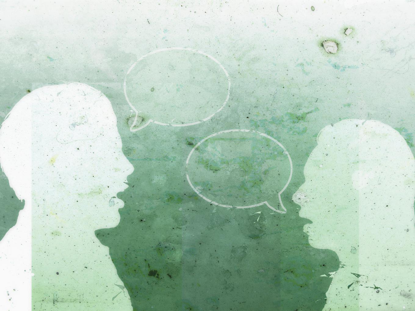 Silhouettes of two people in conversation, with empty speech bubbles floating between them
