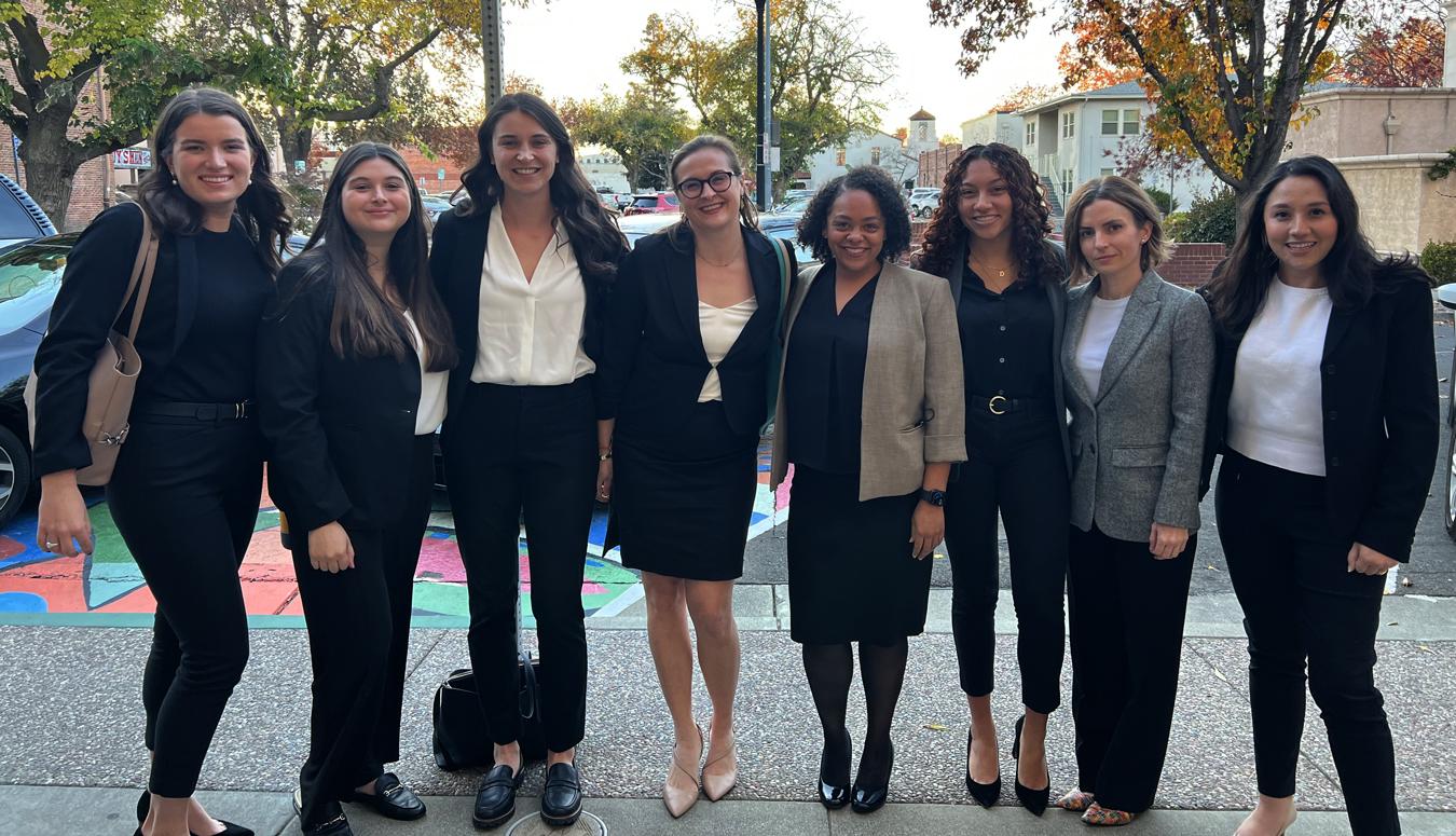 Maddie Campbell posing with a group of women on a sidewalk