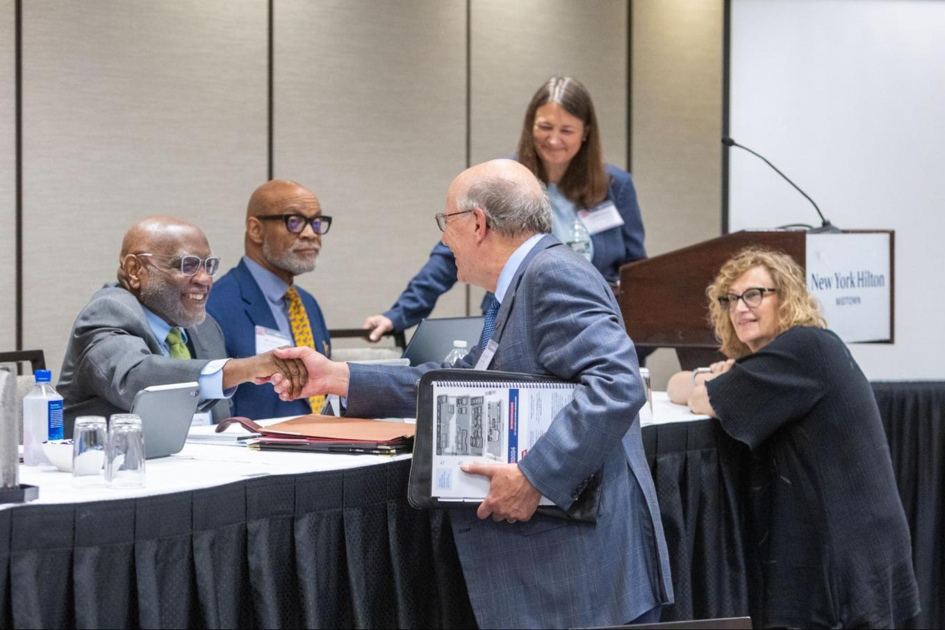 Harry Katz shaking panelists' hands at Triad Conference