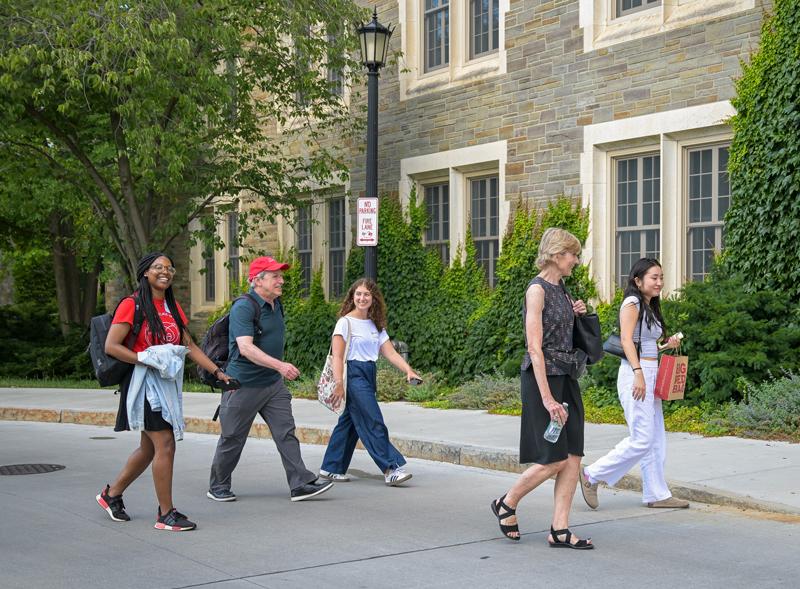 Ed Baum ’81 and Holly Wallace walking on Cornell's campus with NFTE students