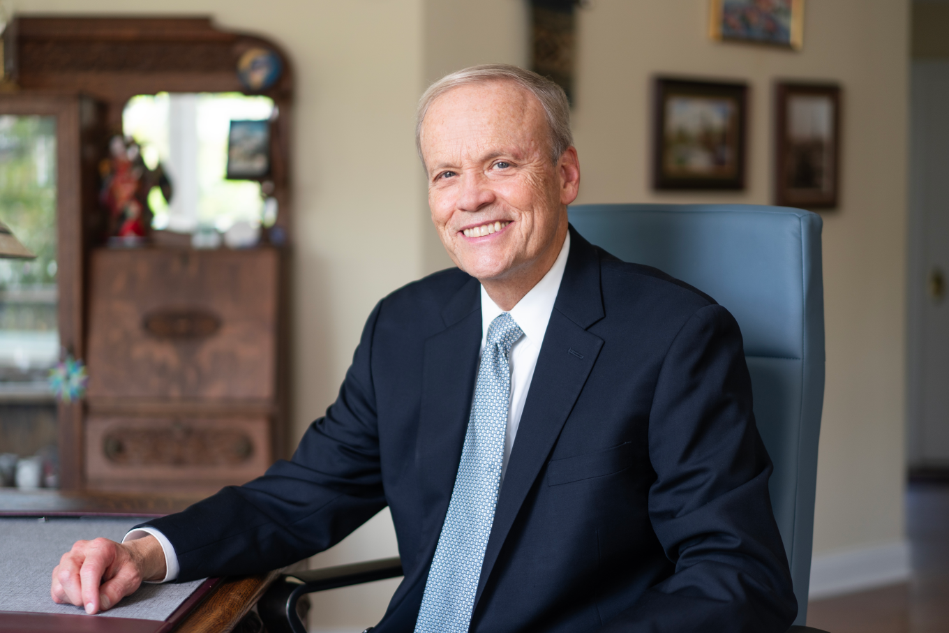 Scott Buchheit, M.S. '77 sitting at a desk in his home office. 