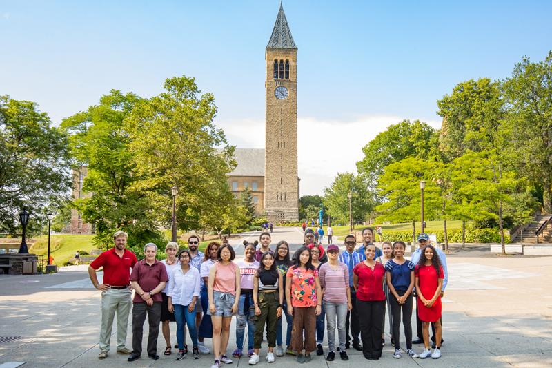 Ed Baum '81 and Holly Wallace with about 20 students on Hoy Plaza with the clock tower in the background