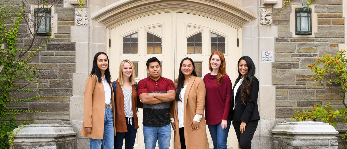six MILR students standing in front of ILR's Ives Hall