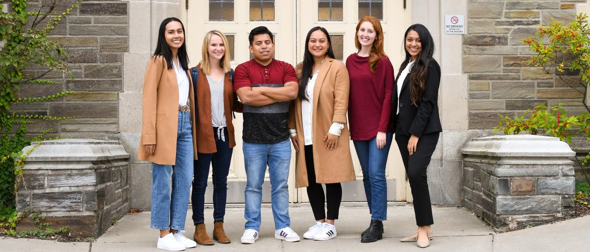 six MILR students standing in front of ILR's Ives Hall