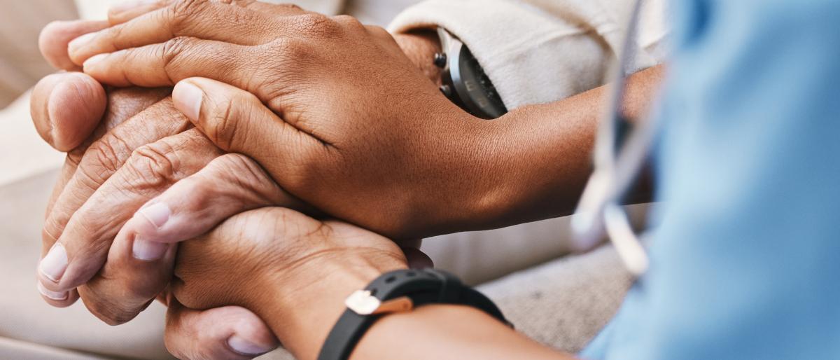 Nurse holding patient's hands