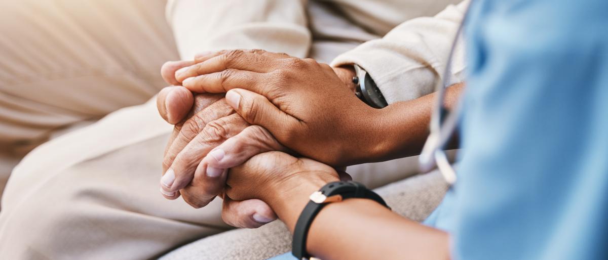 Nurse holding patient's hands