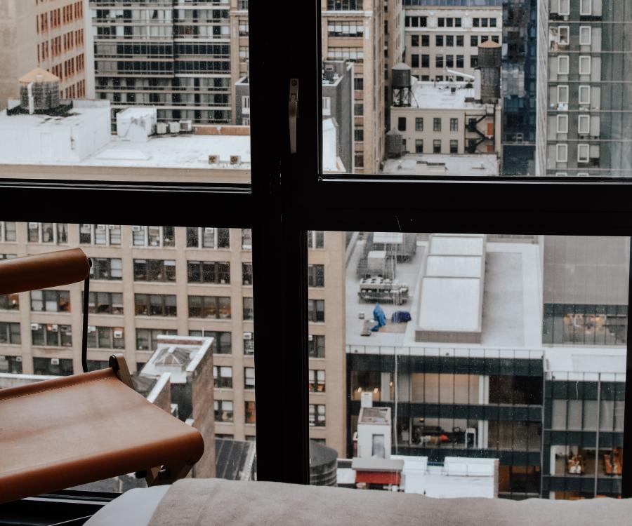 View out of a high-story window on cityscape of tall buildings