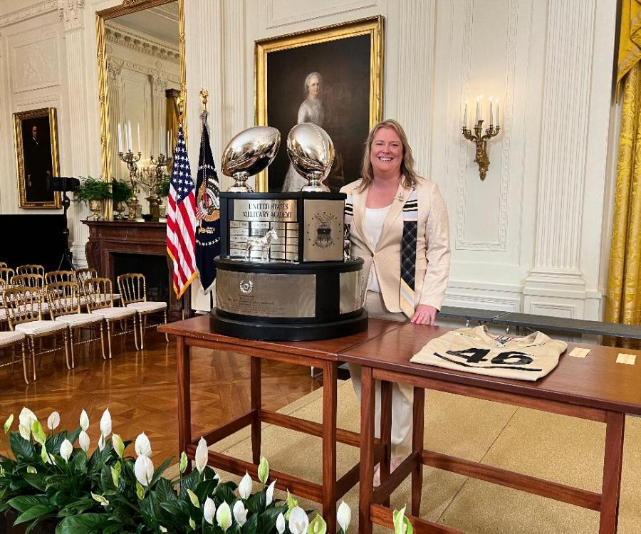 Tricia Brandenburg ’99 poses with the Commander-in-Chief Trophy in the East Room of the White House in May of 2024. The trophy is given annually to the winner of the college football series between Army West Point, Navy and Air Force. 