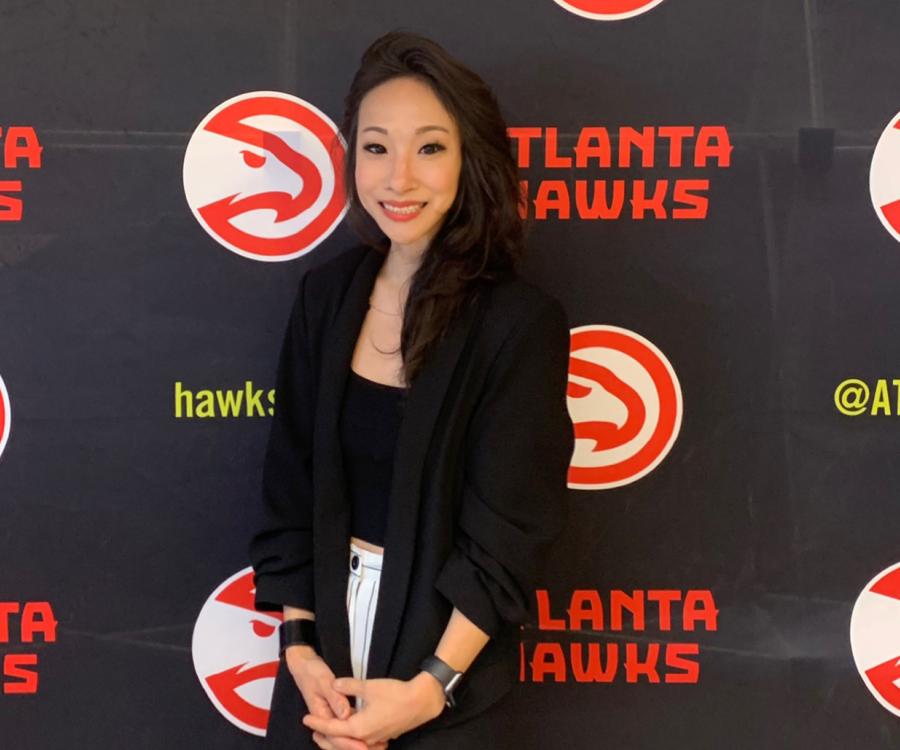 Jennifer Choi ’08 standing in front of an Atlanta Hawks step and repeat. 
