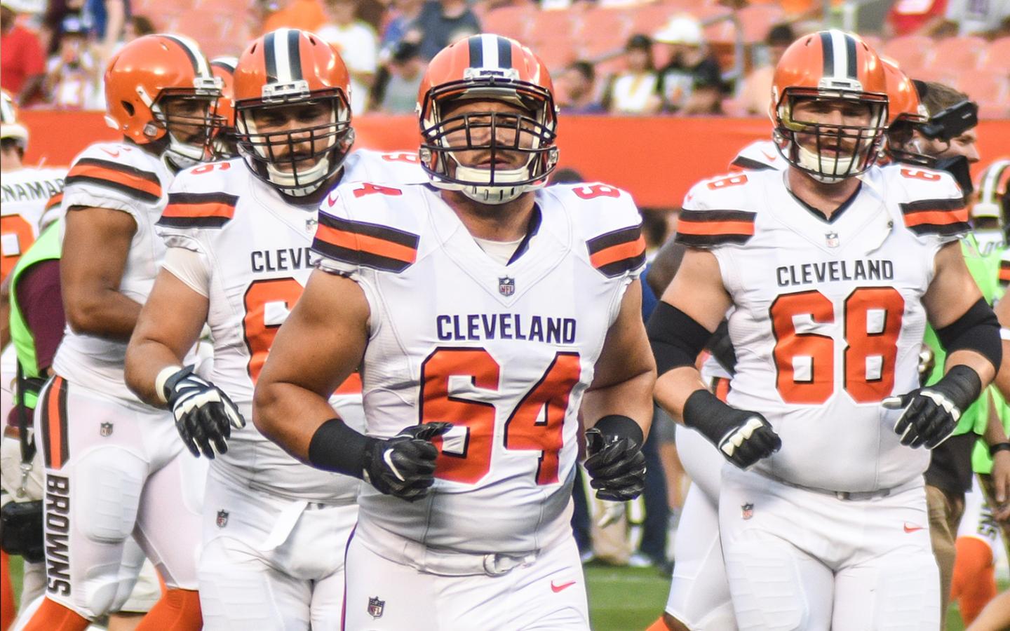 JC Tretter (#64) leads the Cleveland Browns’ offensive line onto the field (Erik Drost).