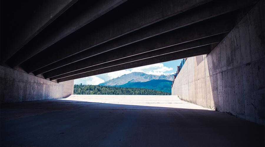 view of a mountain through a tunnel to illustrate the concept of emerging