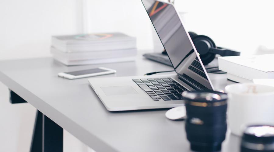 a desk with a laptop to illustrate the idea of working remotely