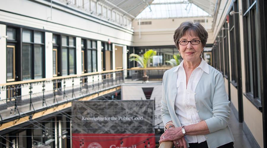 Lou Jean Fleron standing in the Cornell Buffalo building's atrium.