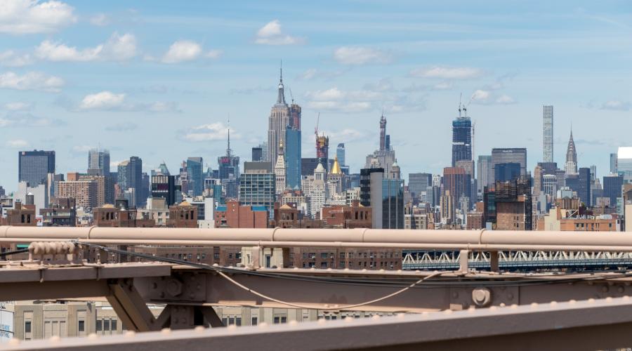 daytime view of manhattan skyline with girders in foreground