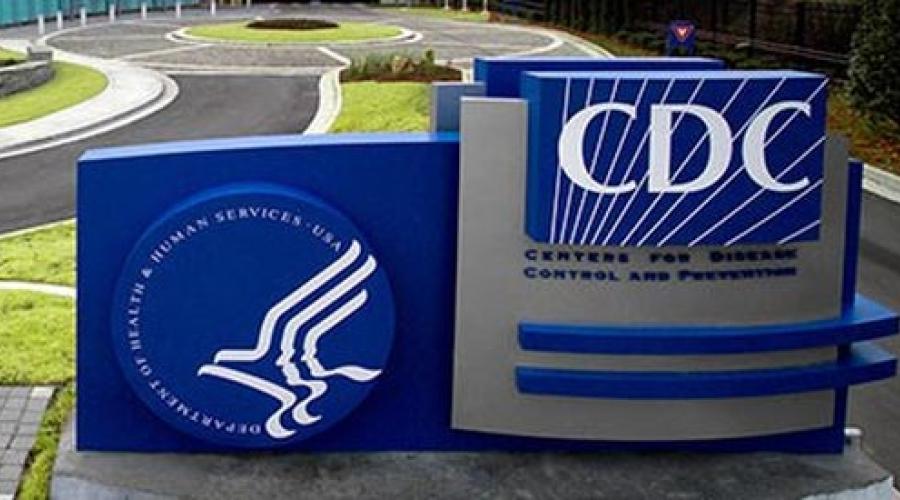 Center for Disease Control logo on a blue background in a field of grass