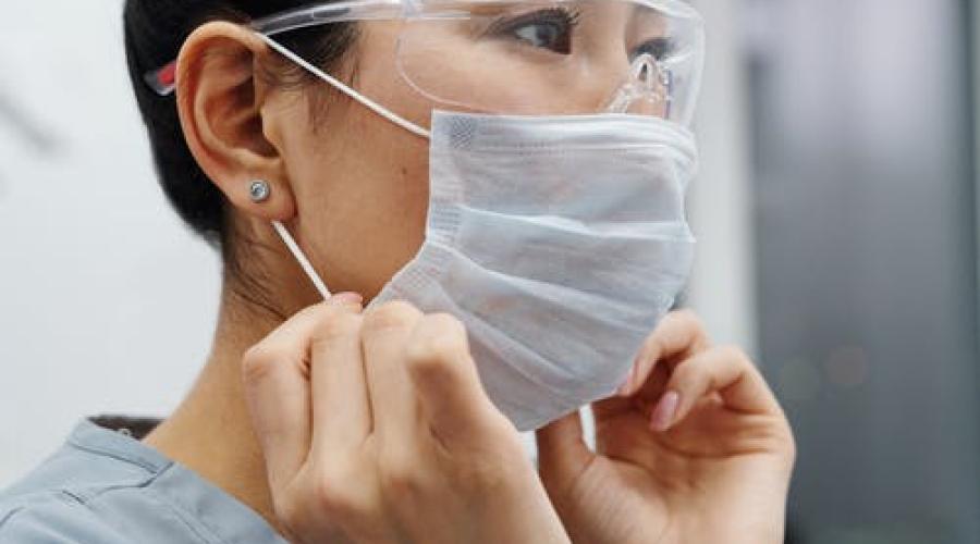 Image of a nurse putting on a mask.