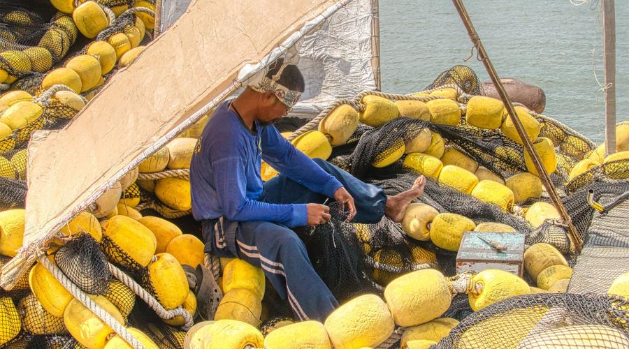 Philippine fisherman surrounded by buoys