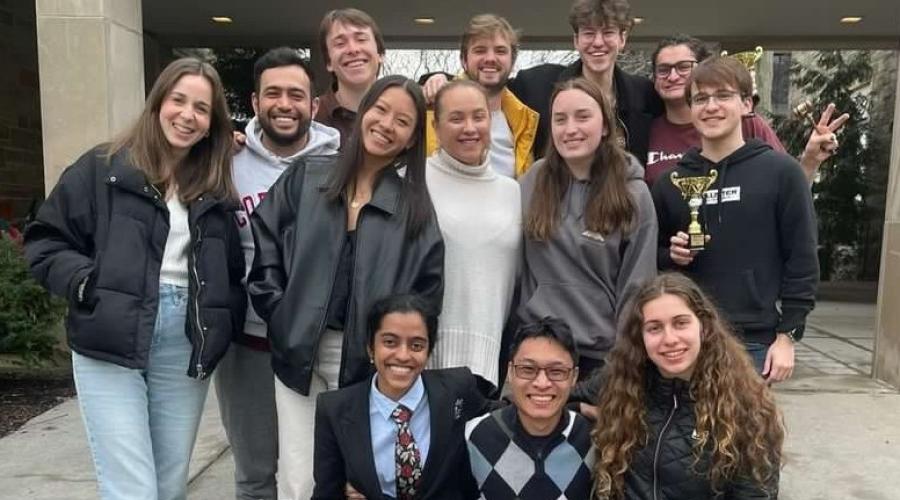A group of students pose in front of Ives Hall