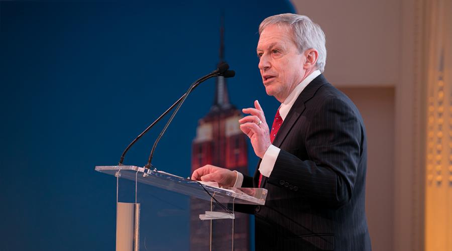 Ed Baum speaking at a lectern