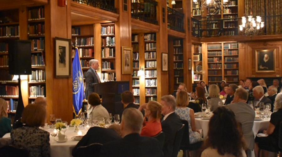 Scott Smith speaking to a group of seated people in a library.