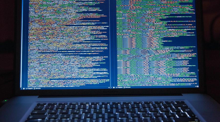 laptop computer screen displaying parallel coding windows