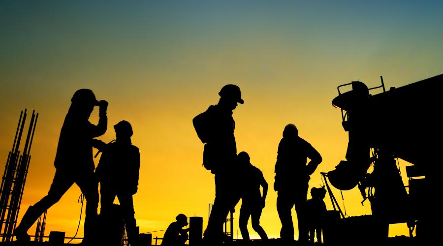 silhouette of construction wokers at a jobsite