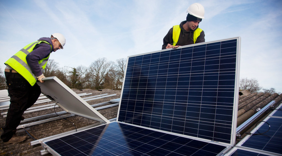 Solar workers installing panels
