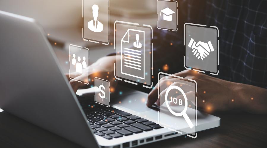 Visualization of business activities as icons floating around a person working on a laptop .