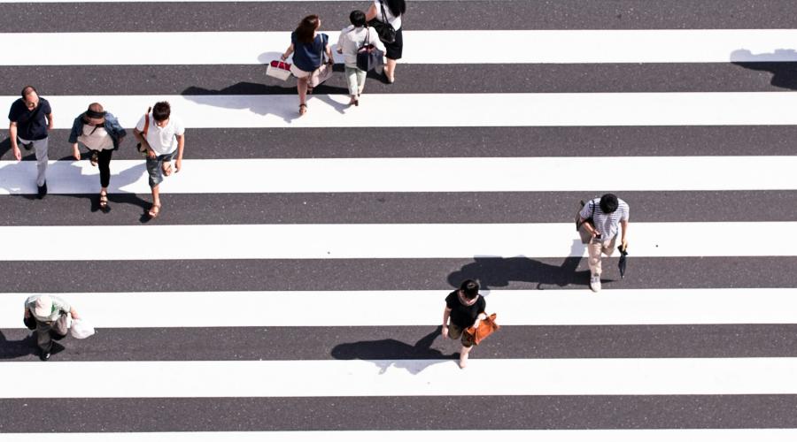 Birds' eye view of people crossing in a crosswalk.