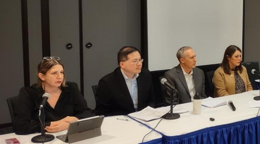 Photo of the panelists sitting behind a table