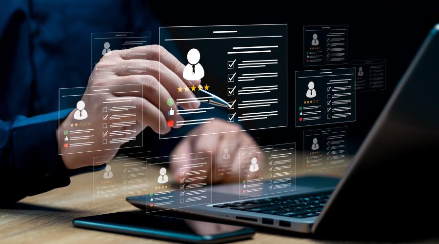Image of hands with a pen selecting something on a transparent screen with a person profile on it