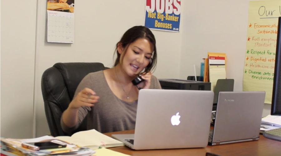 Student seated at a desk conducting a phone interview