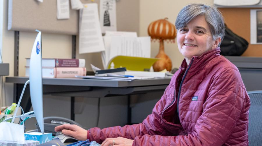 Senior lecturer Elizabeth Karns works at a computer in her office .