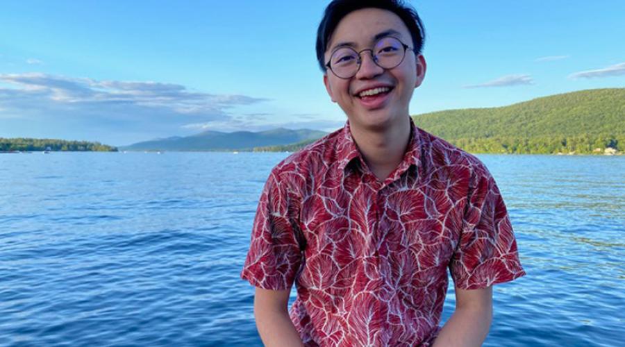 Dustin Liu ’19 sitting by Cayuga Lake