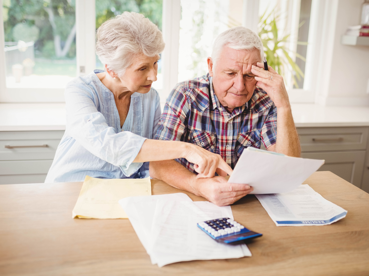 An elderly couple go over their finances.