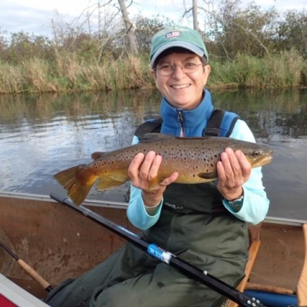 Andrea Dutcher holding a fish she caught.