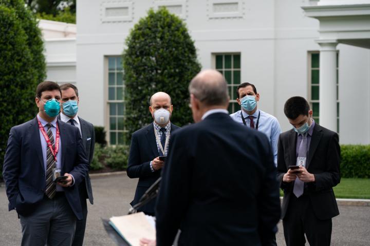 Reporters listening to Larry Kudlow speak on Friday outside the White House