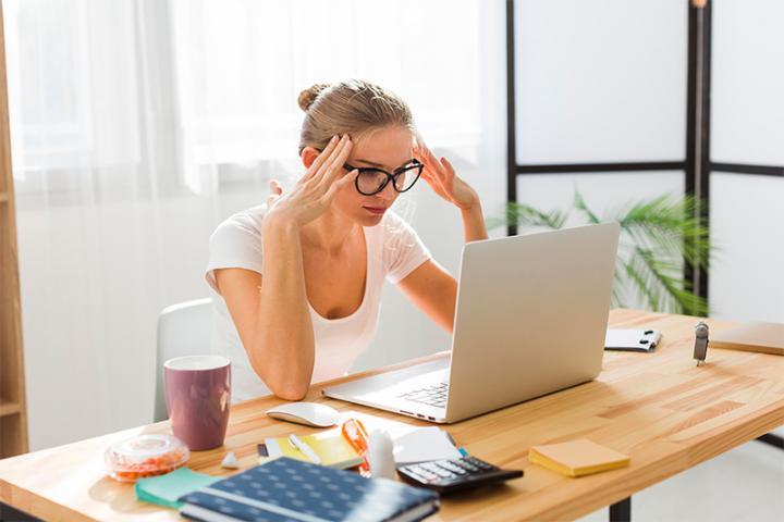 Woman working from home showing frustration