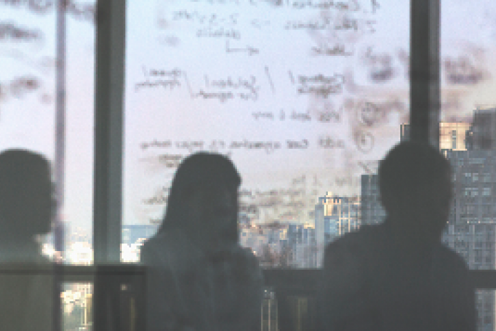 People looking out the window of a skyscraper