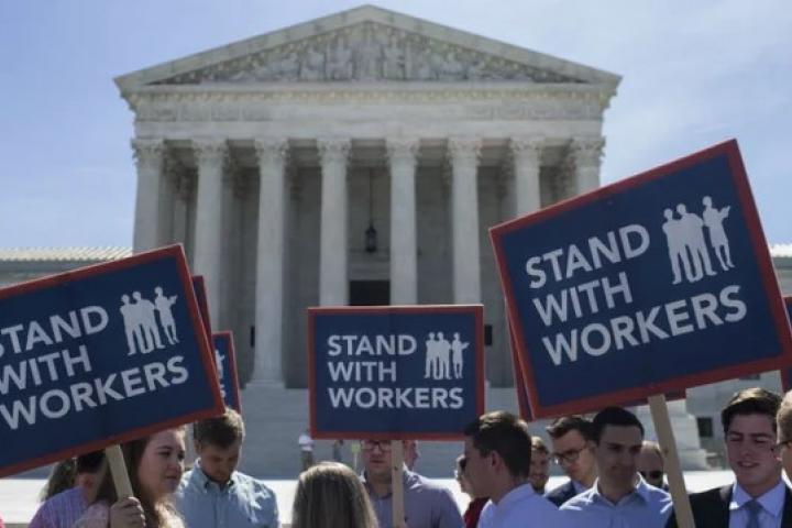 Protestors with Stand With Workers Signs