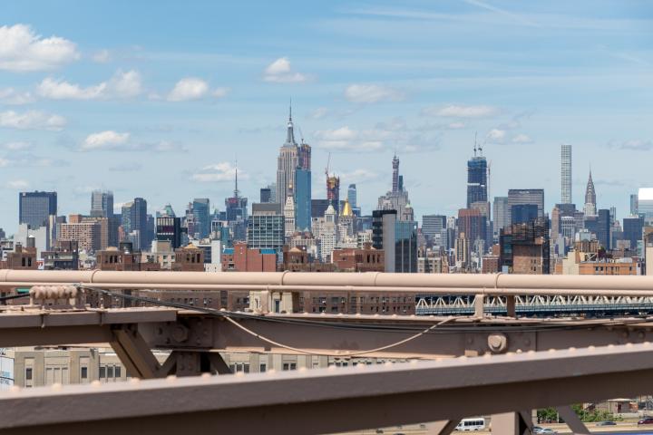 daytime view of manhattan skyline with girders in foreground