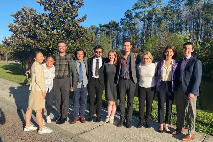 Members of the Cornell Speech program pose in suits before the tournament