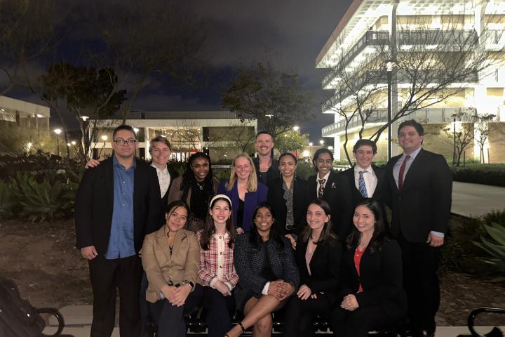 Students pose in suits after a day of competition