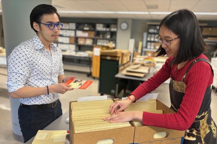 Sean Chang of Catherwood Library and Claire Deng of the Kheel Center look through some of the China Labor Collection files in the Kheel Center.