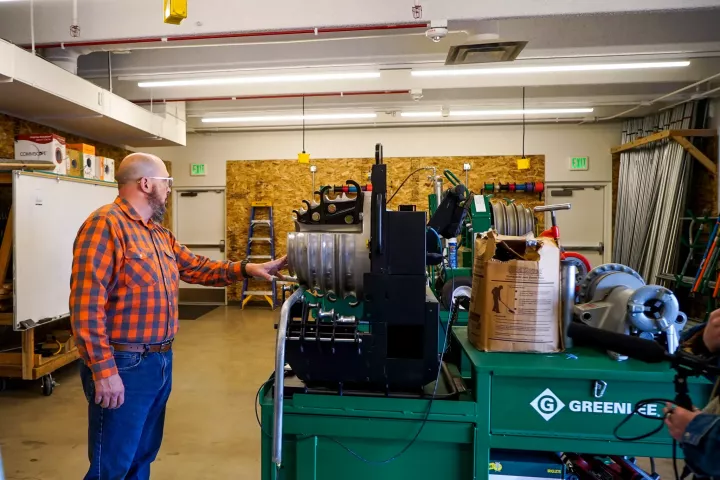 Training director Dan Hendricks points out a power bender in a training room at the IBEW Denver Joint Electric Apprenticeship and Training Committee. Jan. 16, 2025.