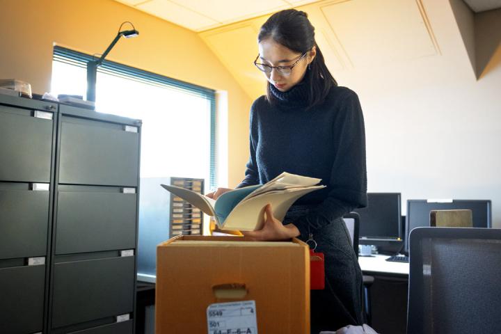 Claire Deng ’22, collections survey assistant, is surveying archival materials at the Kheel Center for Labor-Management Documentation and Archives, to find and describe the historical records of marginalized groups in archival collections. Jason Koski/Cornell University