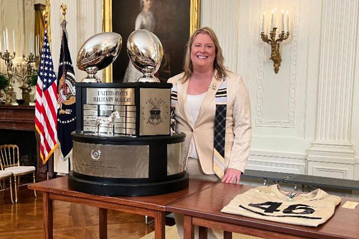 Tricia Brandenburg ’99 poses with the Commander-in-Chief Trophy in the East Room of the White House in May of 2024. The trophy is given annually to the winner of the college football series between Army West Point, Navy and Air Force. 