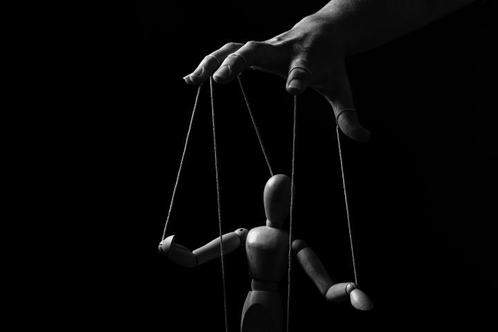 Hand manipulating a marionette
