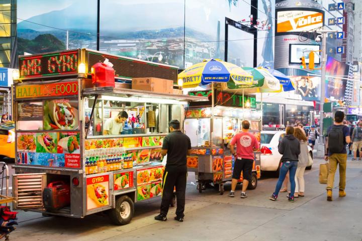 People standing in front of food carts