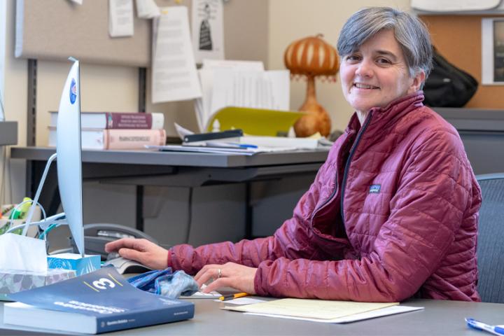 Senior lecturer Elizabeth Karns works at a computer in her office .